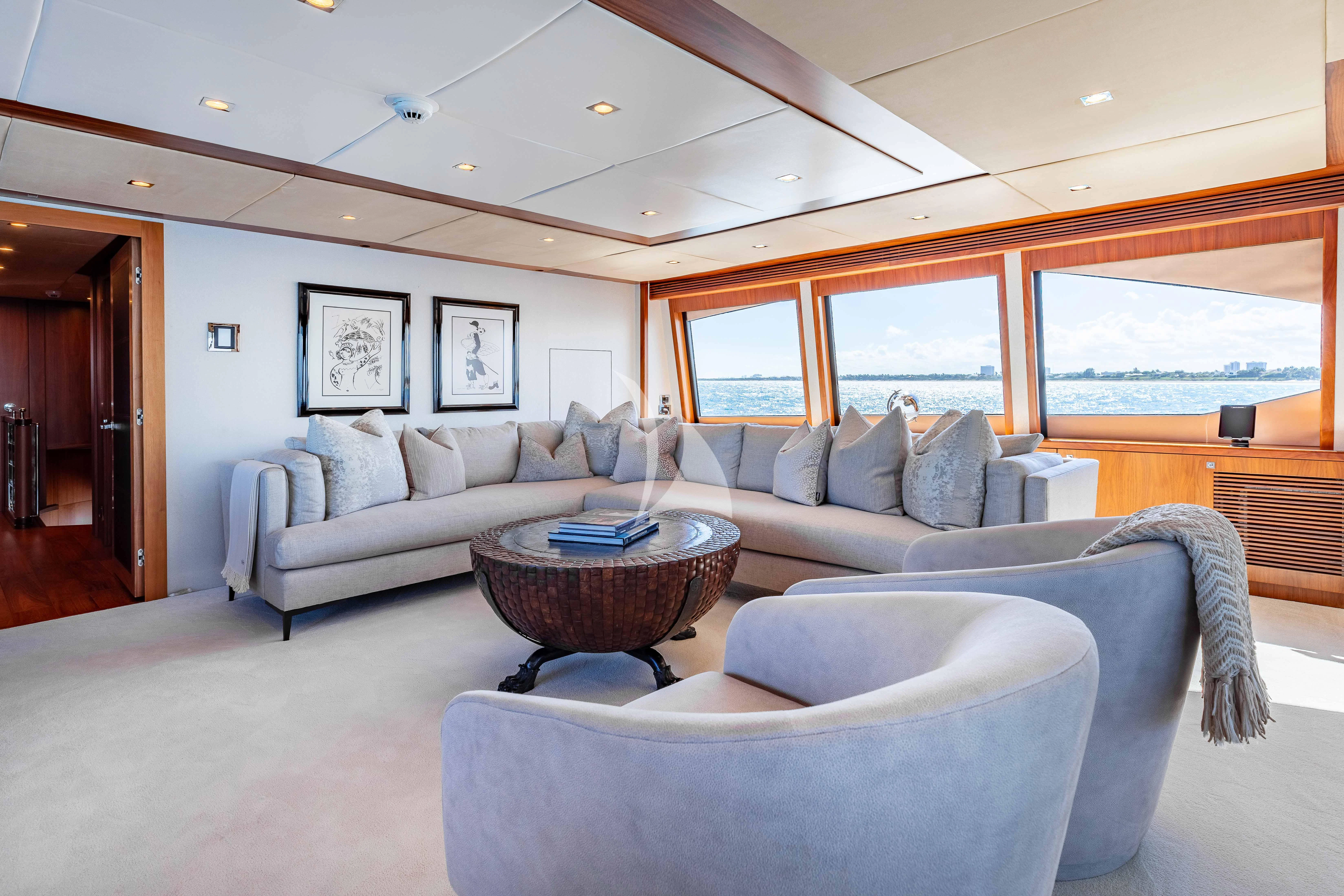 a living room with a couch and a table aboard ABOUT TIME Yacht for Sale