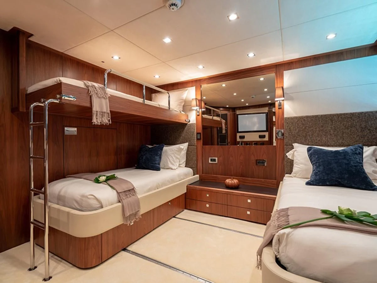a room with a bed and a mirror aboard ABOUT TIME Yacht for Sale