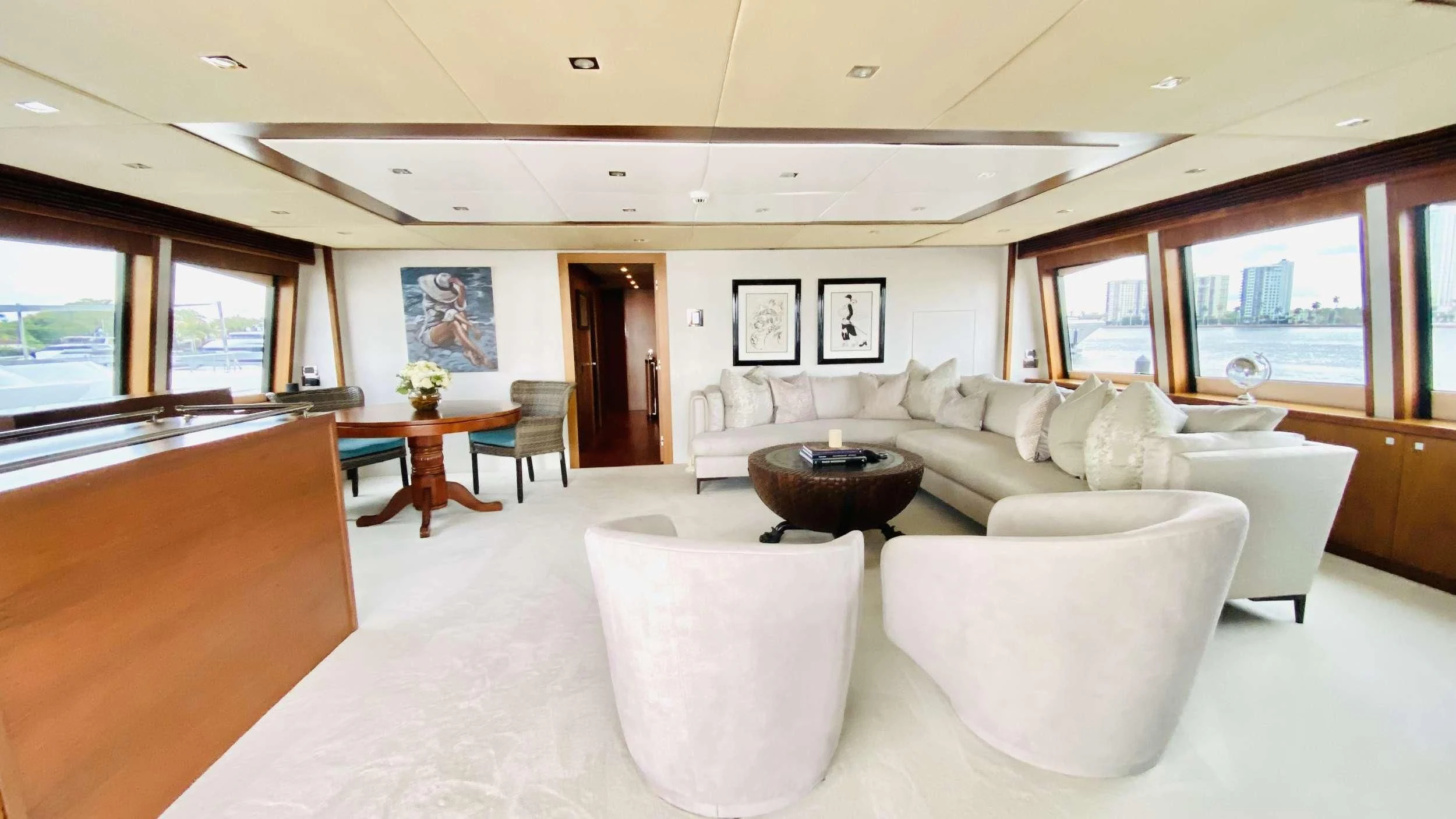 a living room with white furniture aboard ABOUT TIME Yacht for Sale