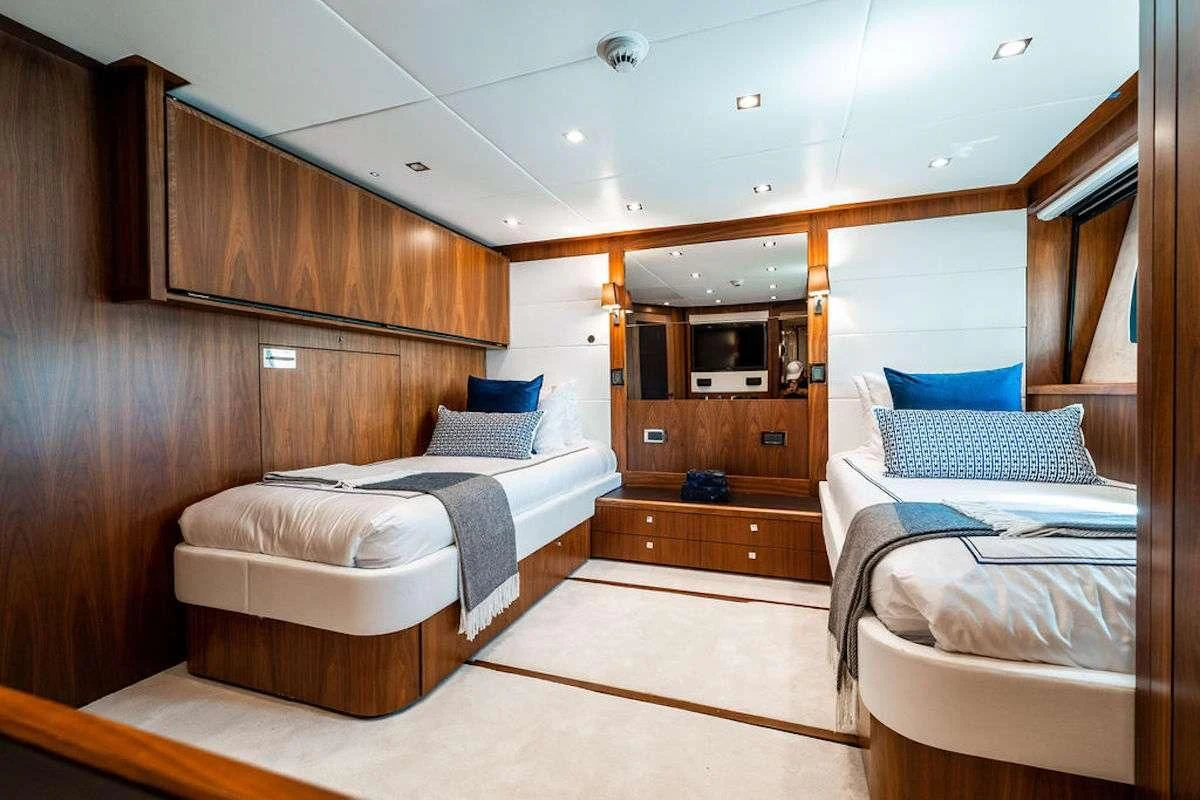 a room with a couple of beds aboard ABOUT TIME Yacht for Sale