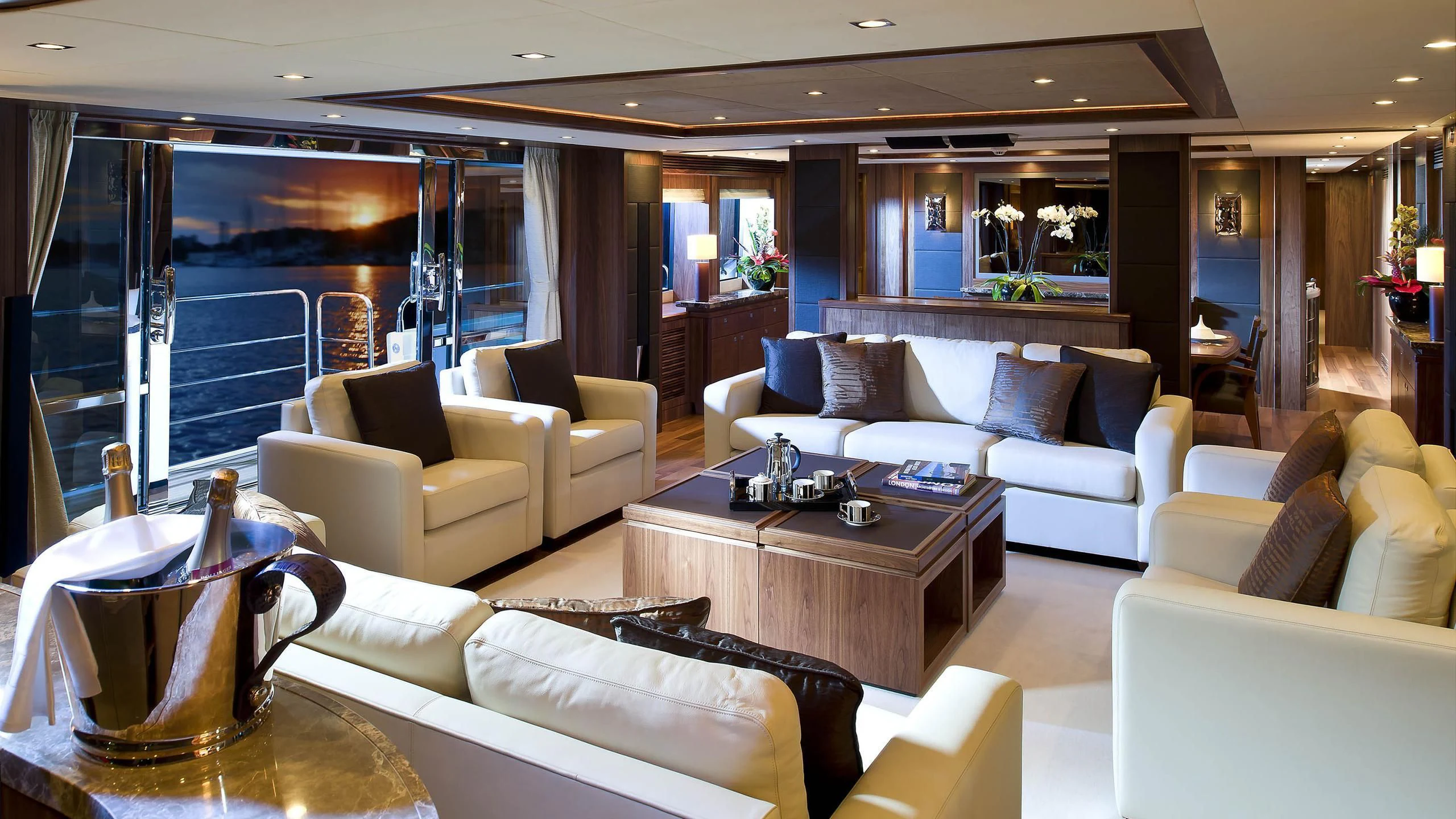 a living room with a glass wall aboard ABOUT TIME Yacht for Sale