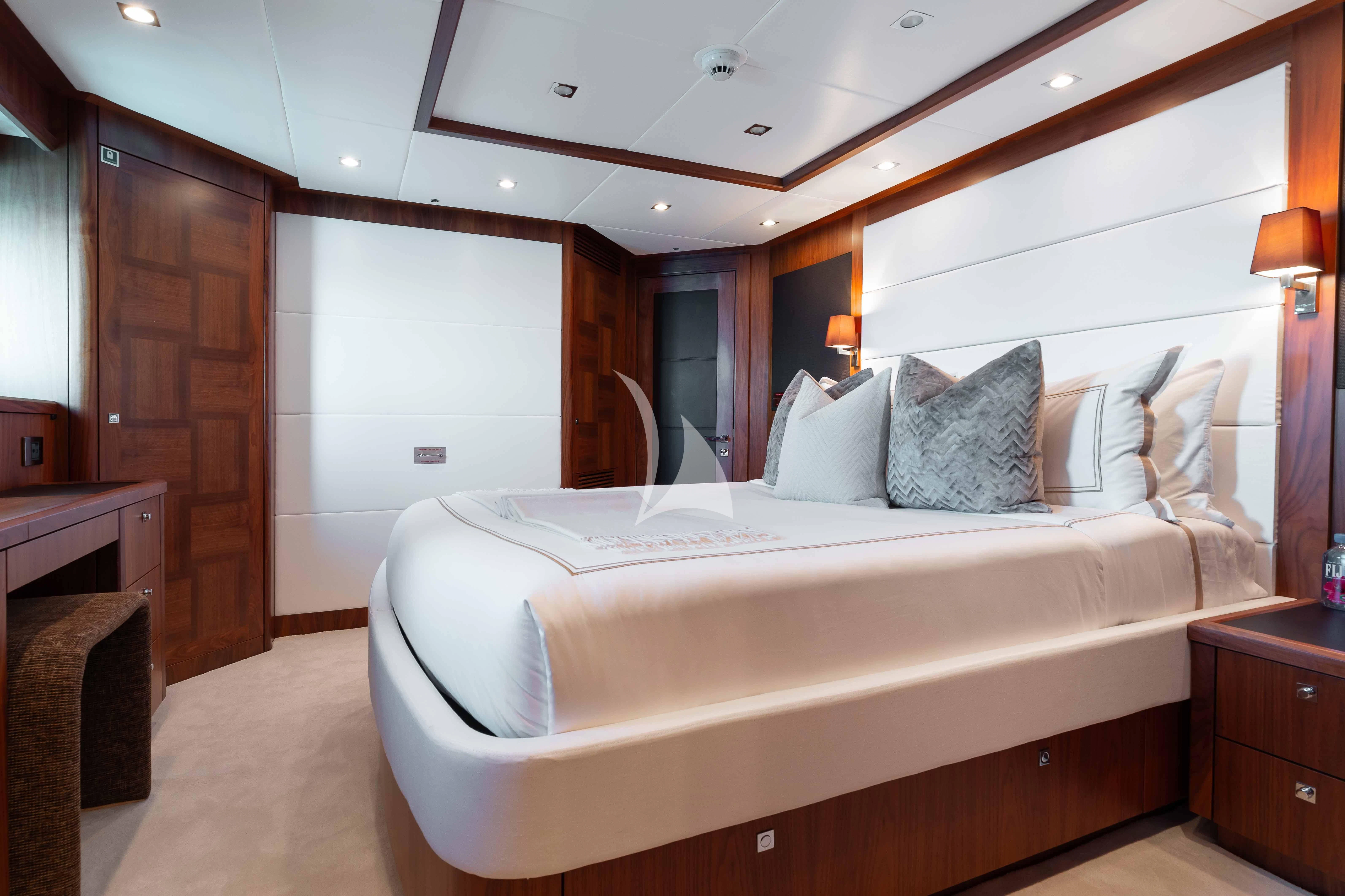 a bedroom with a bed and a wood door aboard ABOUT TIME Yacht for Sale