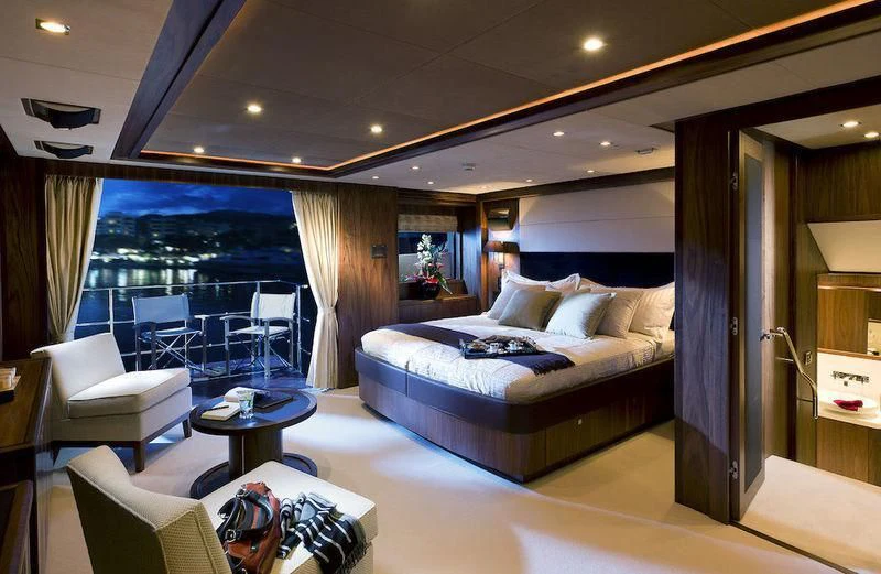 a hotel room with a large bed aboard ABOUT TIME Yacht for Sale