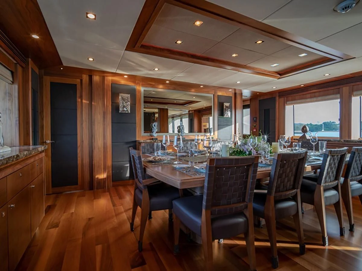 a large dining room with a large table and chairs aboard ABOUT TIME Yacht for Sale