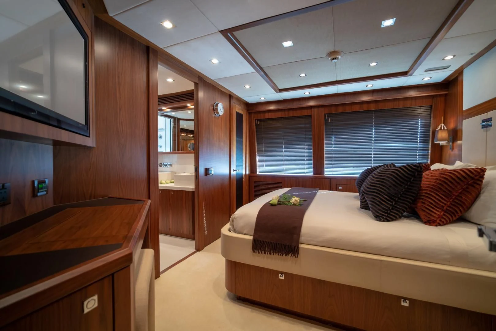a bedroom with a bed and desk aboard ABOUT TIME Yacht for Sale
