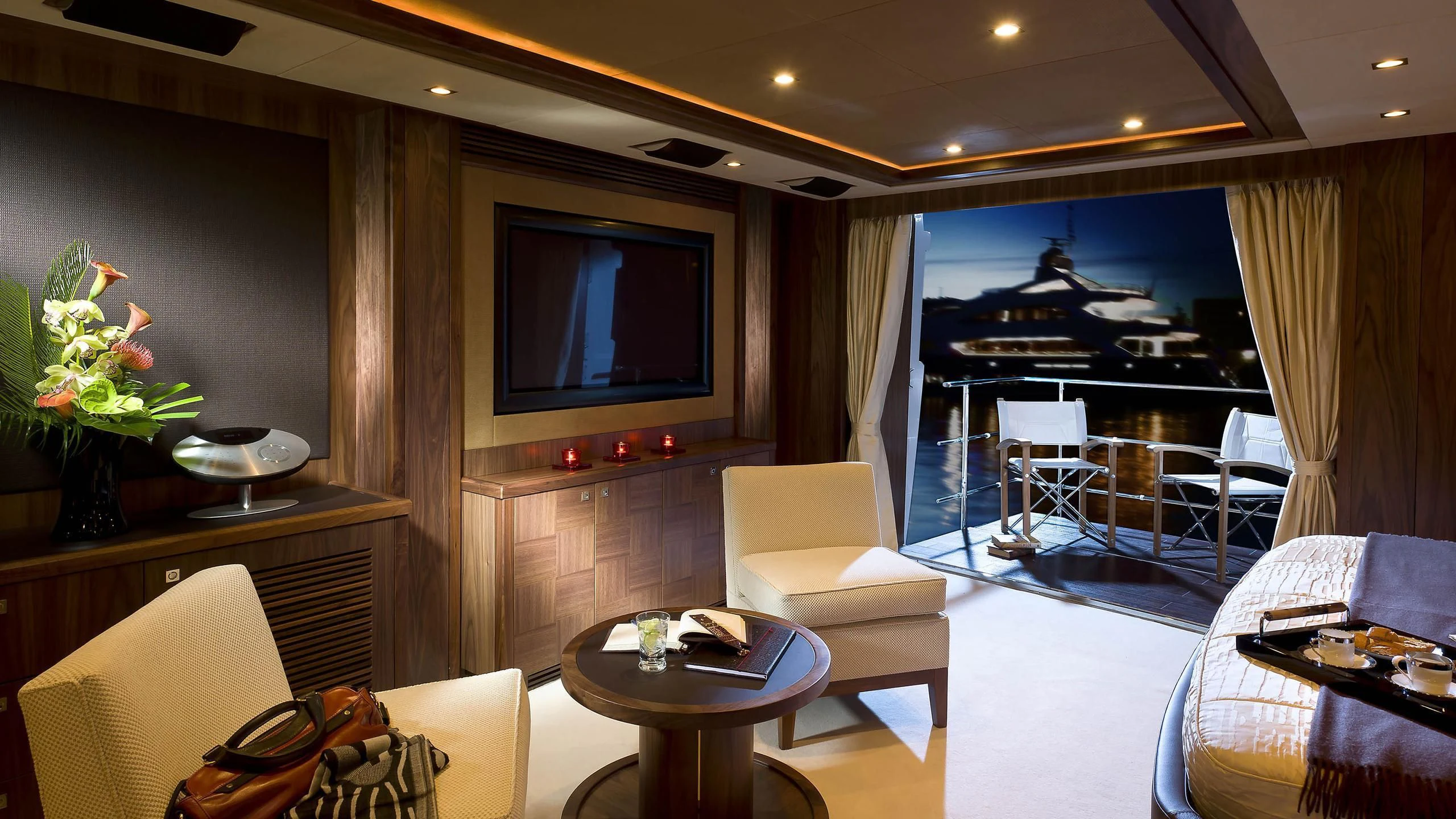 a living room with a tv and furniture aboard ABOUT TIME Yacht for Sale