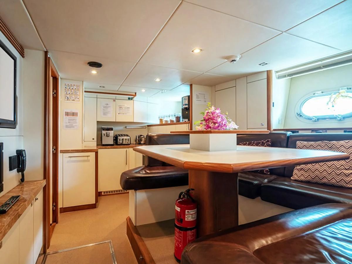 a kitchen with a table and chairs aboard ABOUT TIME Yacht for Sale