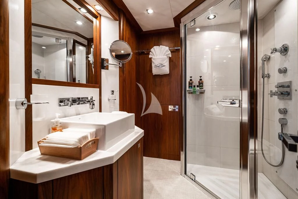 a bathroom with a glass shower aboard ABOUT TIME Yacht for Sale