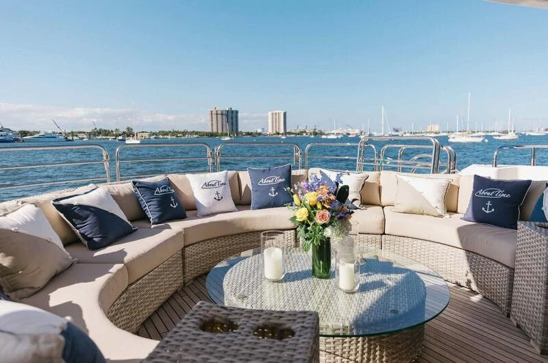 a patio with a table and chairs aboard ABOUT TIME Yacht for Sale