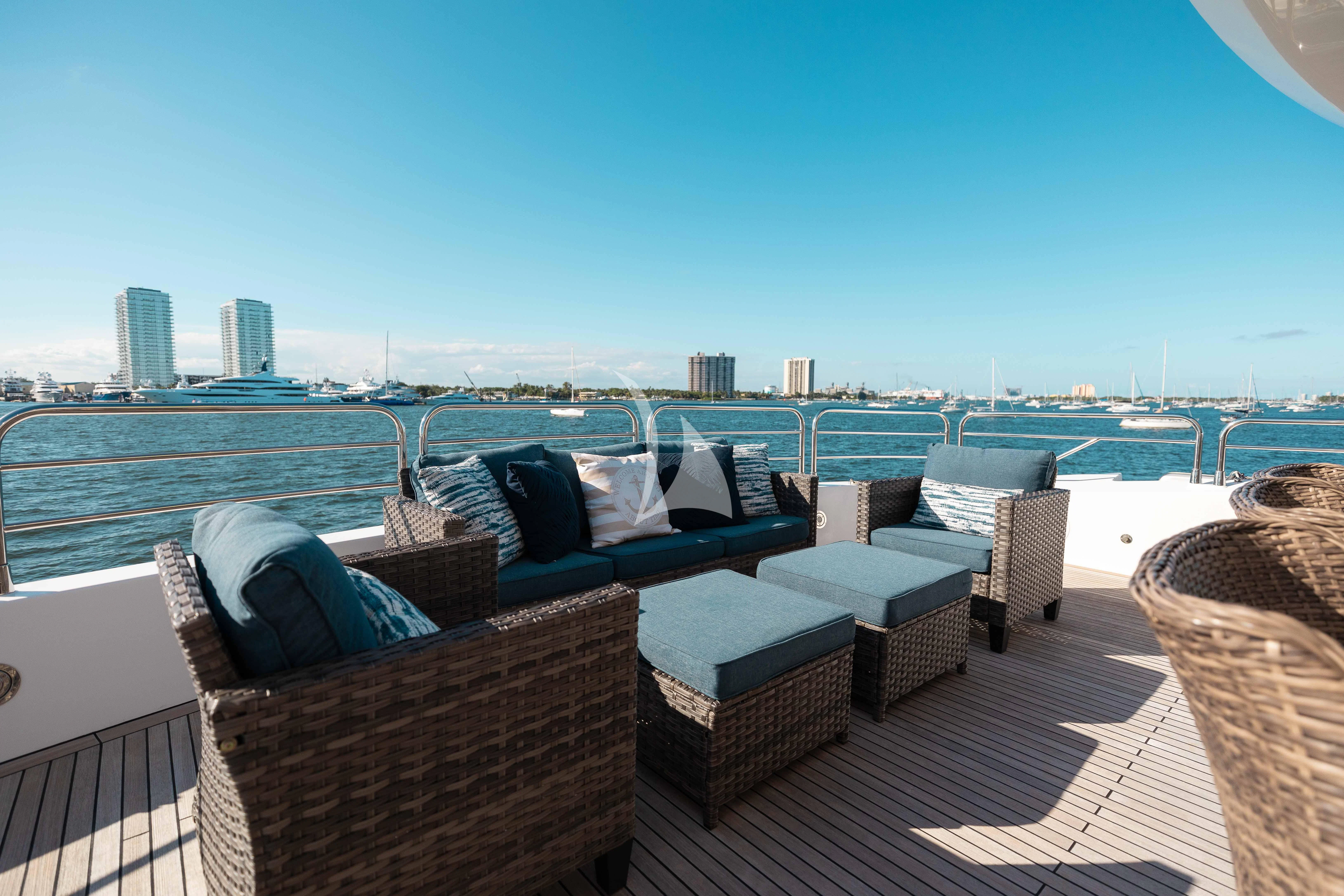 a deck with chairs and a city in the background aboard ABOUT TIME Yacht for Sale
