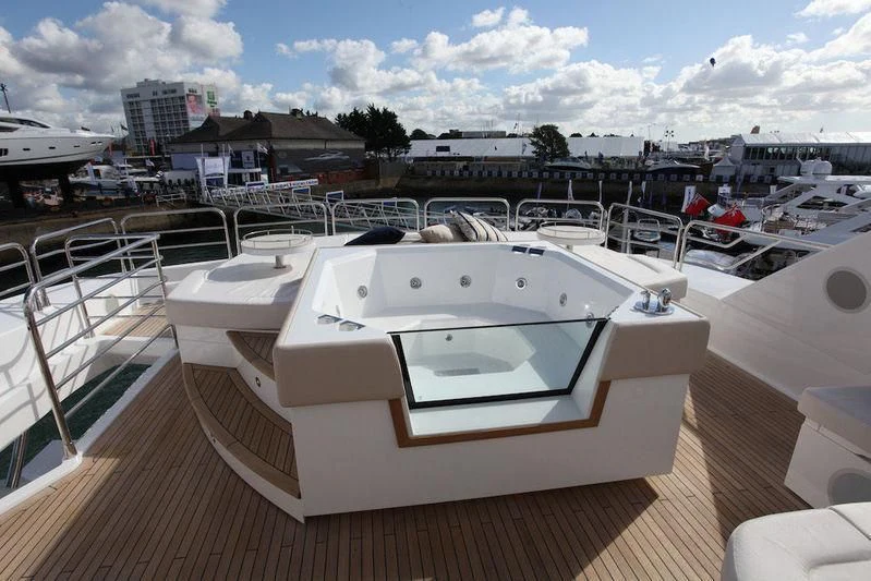a large white boat in a harbor aboard ABOUT TIME Yacht for Sale