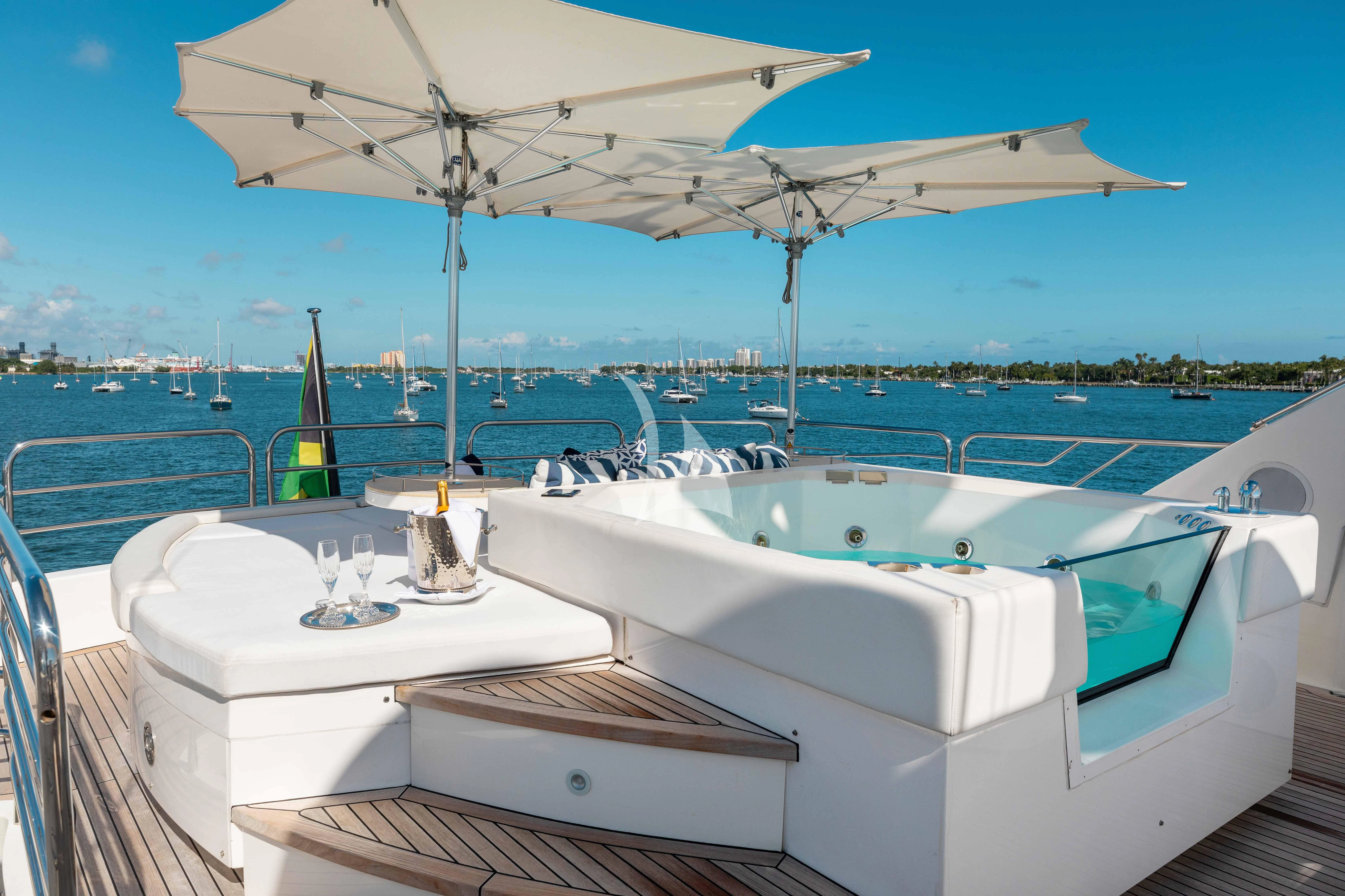 a couple of bathtubs with a sink and a umbrella on a boat aboard ABOUT TIME Yacht for Sale