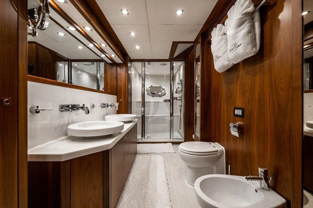 a bathroom with a sink toilet and a mirror aboard ABOUT TIME Yacht for Sale