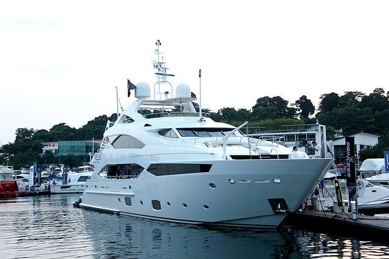 a large white boat in a harbor aboard ABOUT TIME Yacht for Sale