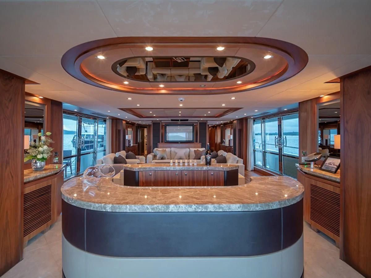a large room with a large round table and a large chandelier aboard ABOUT TIME Yacht for Sale