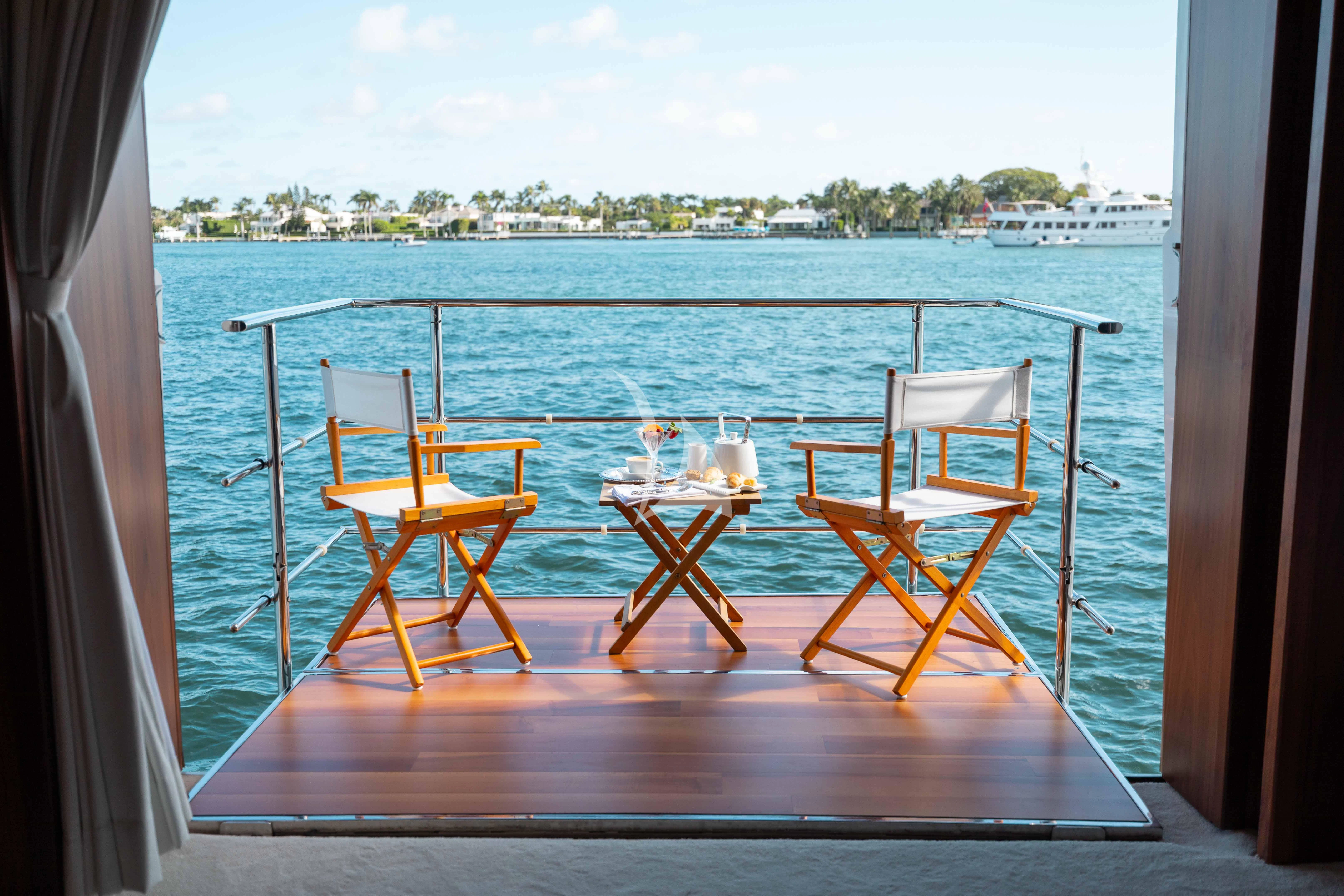 a group of chairs on a deck overlooking a body of water aboard ABOUT TIME Yacht for Sale