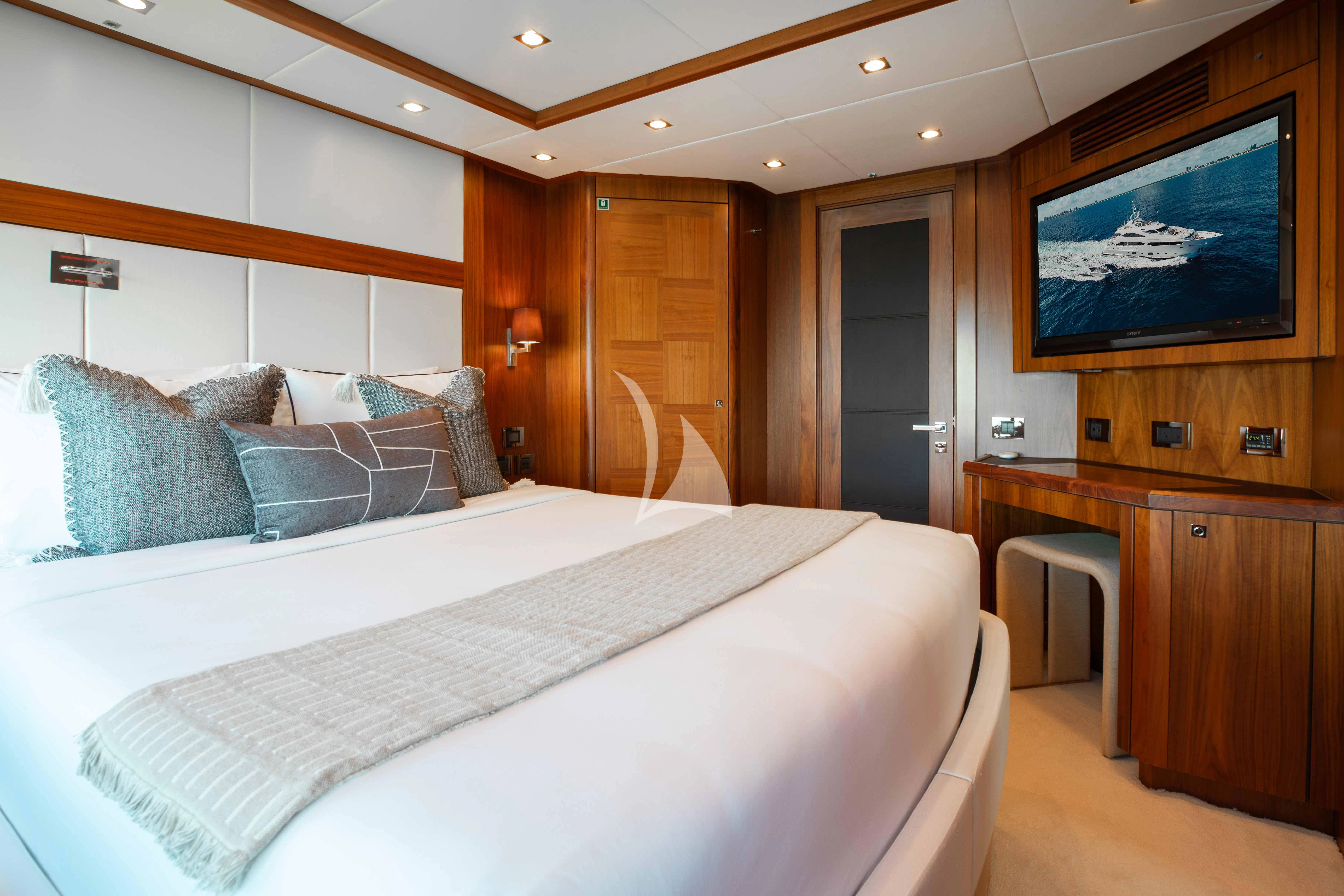 a bedroom with a large bed aboard ABOUT TIME Yacht for Sale