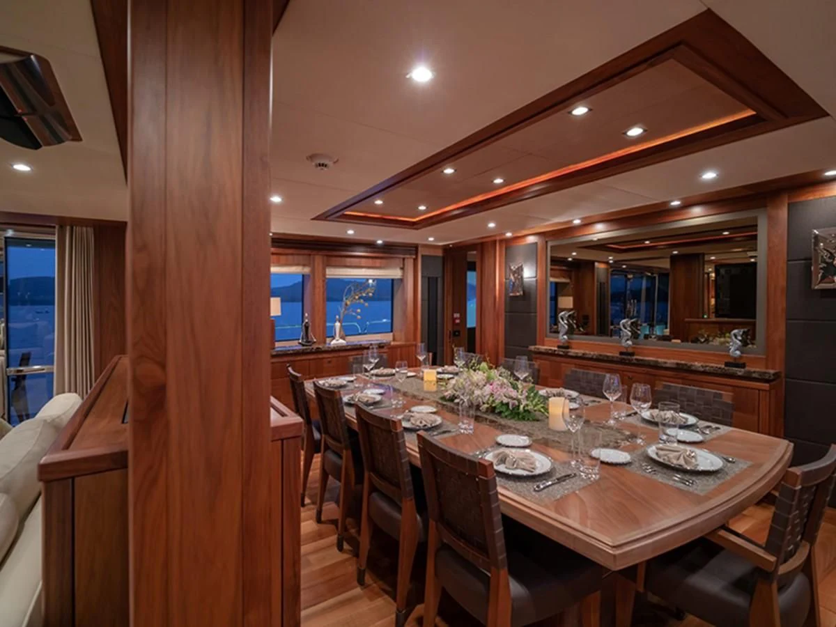 a dining room with a table set aboard ABOUT TIME Yacht for Sale