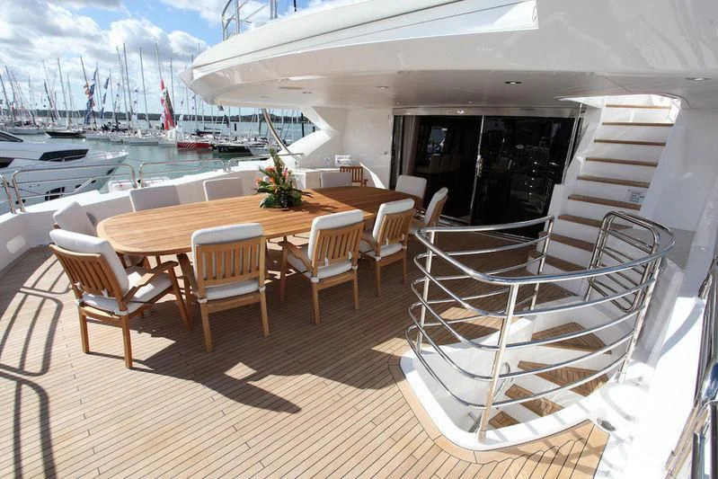 a deck with chairs and tables aboard ABOUT TIME Yacht for Sale