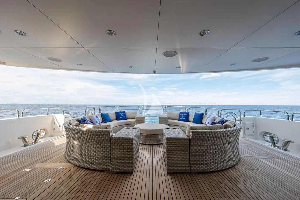a room with a view of the ocean and a couple of chairs aboard ABOUT TIME Yacht for Sale