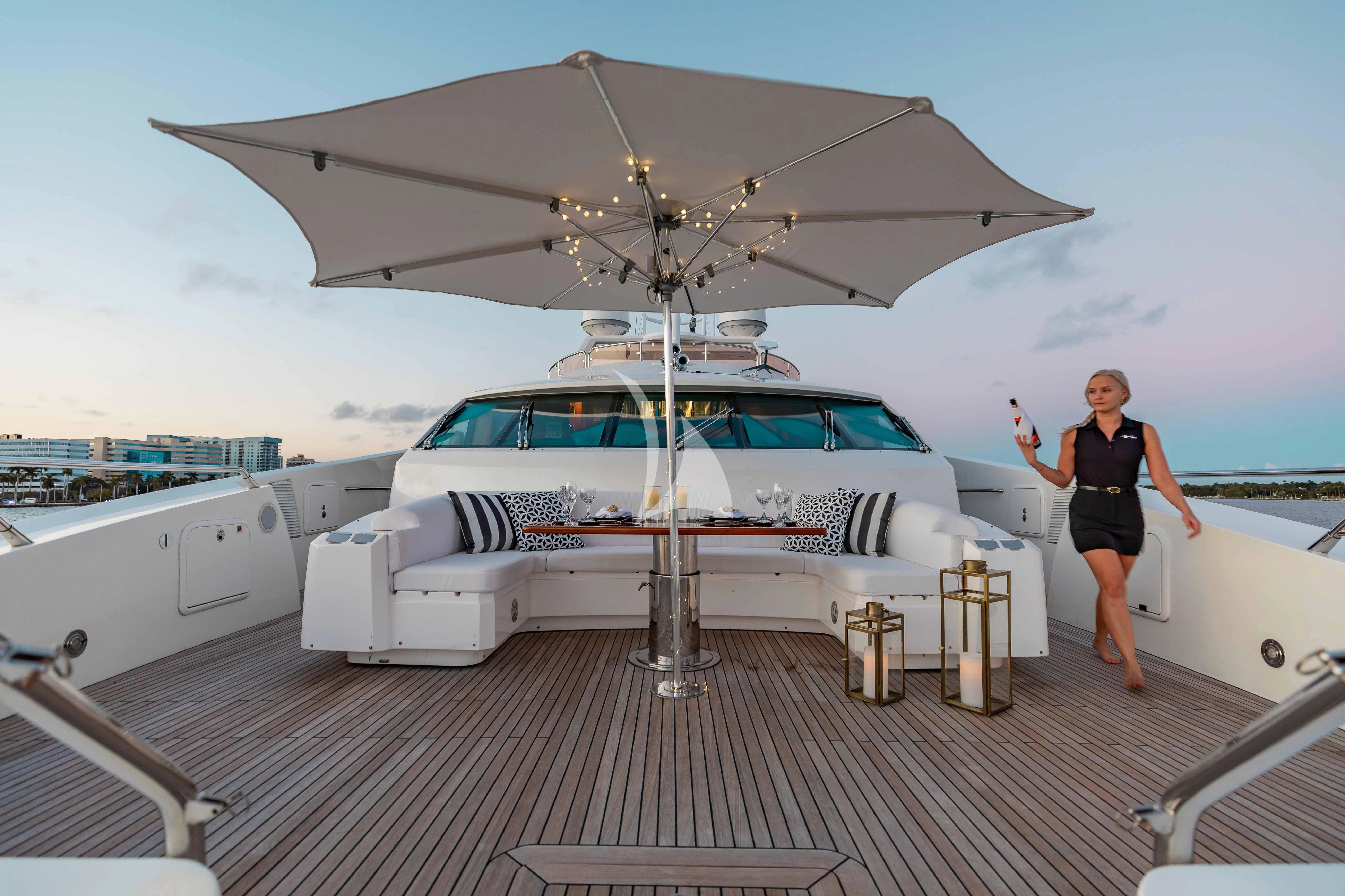 a person walking on a dock next to a white boat aboard ABOUT TIME Yacht for Sale