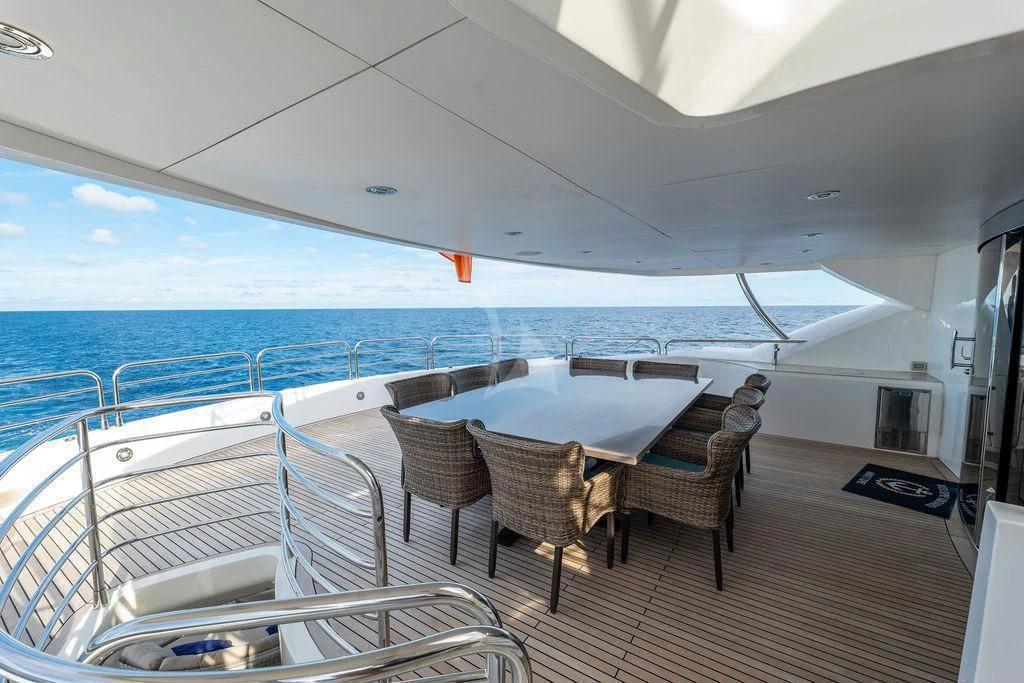 a large white tent with chairs and tables on it aboard ABOUT TIME Yacht for Sale