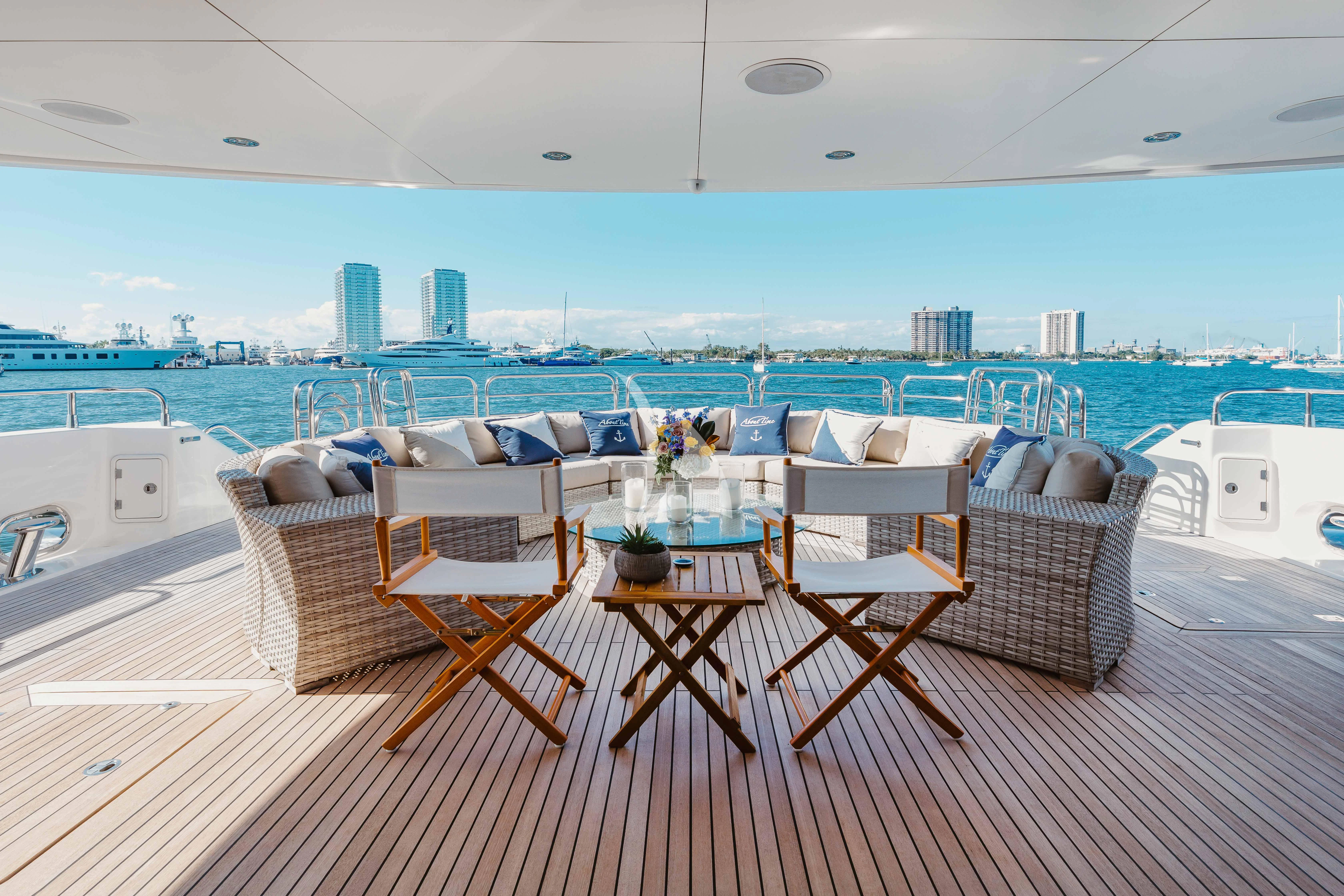 a group of chairs on a deck overlooking a body of water aboard ABOUT TIME Yacht for Sale