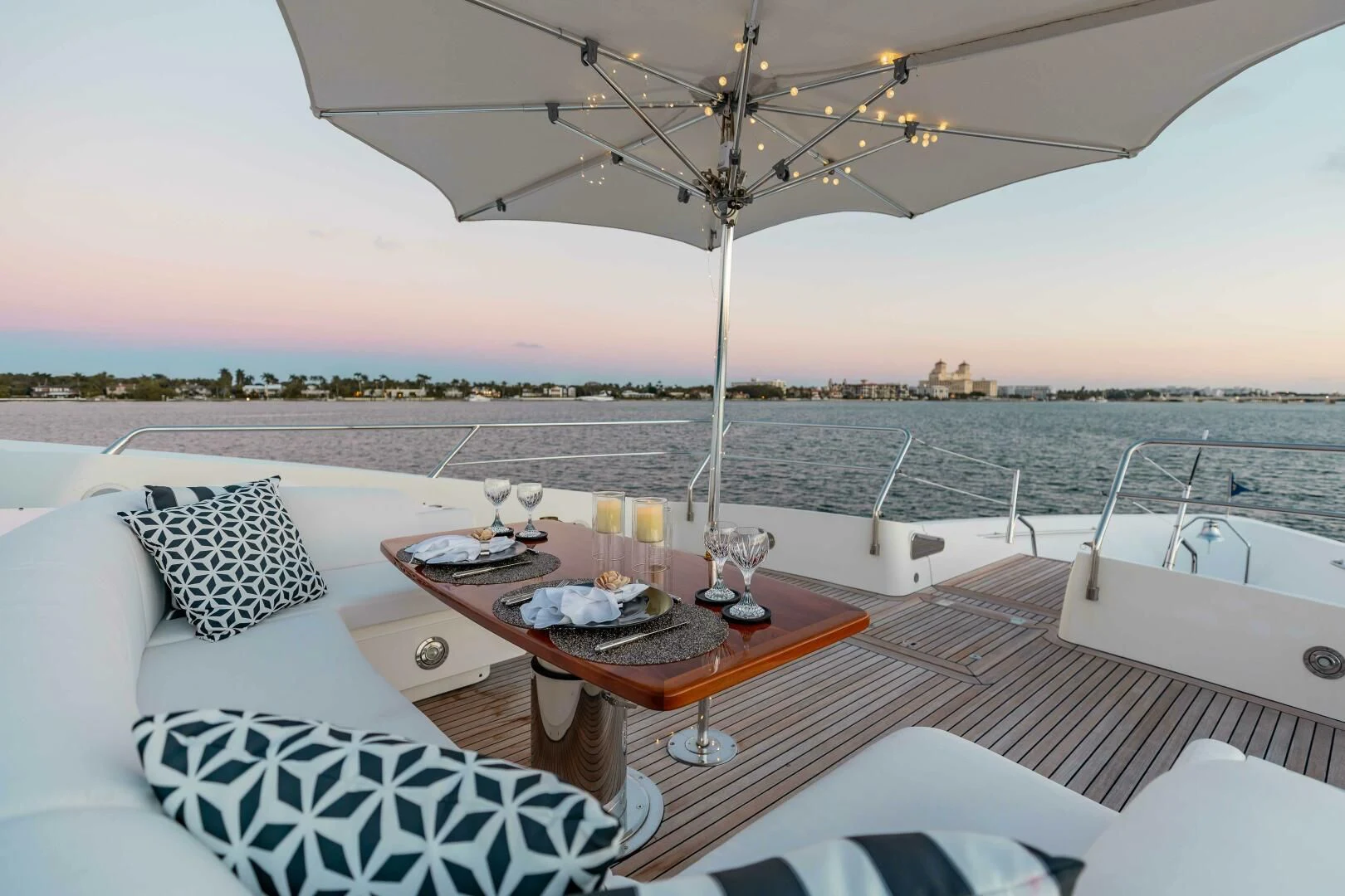 a table with a glass of wine on a boat in the water aboard ABOUT TIME Yacht for Sale