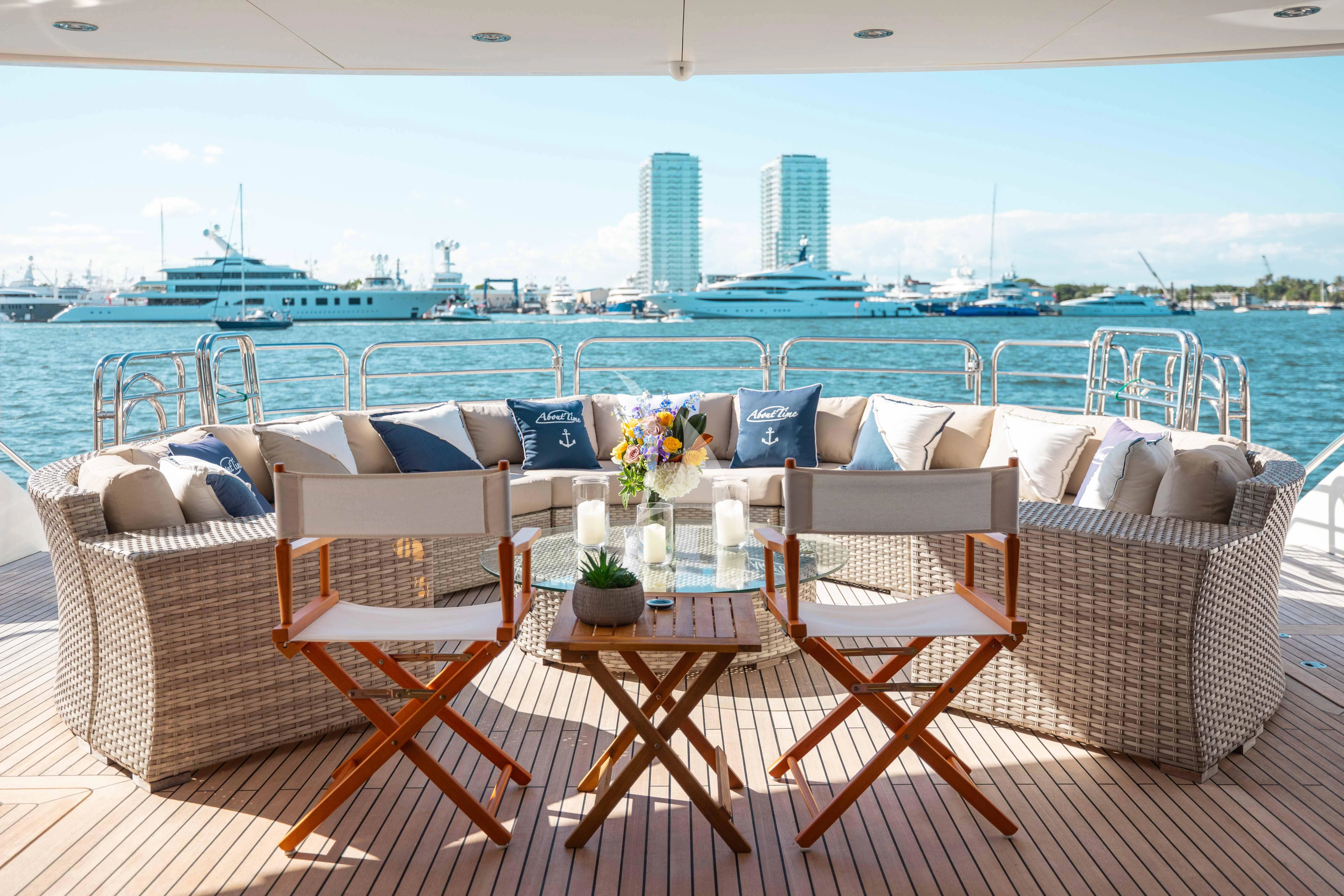 a table set with chairs and a view of a city aboard ABOUT TIME Yacht for Sale