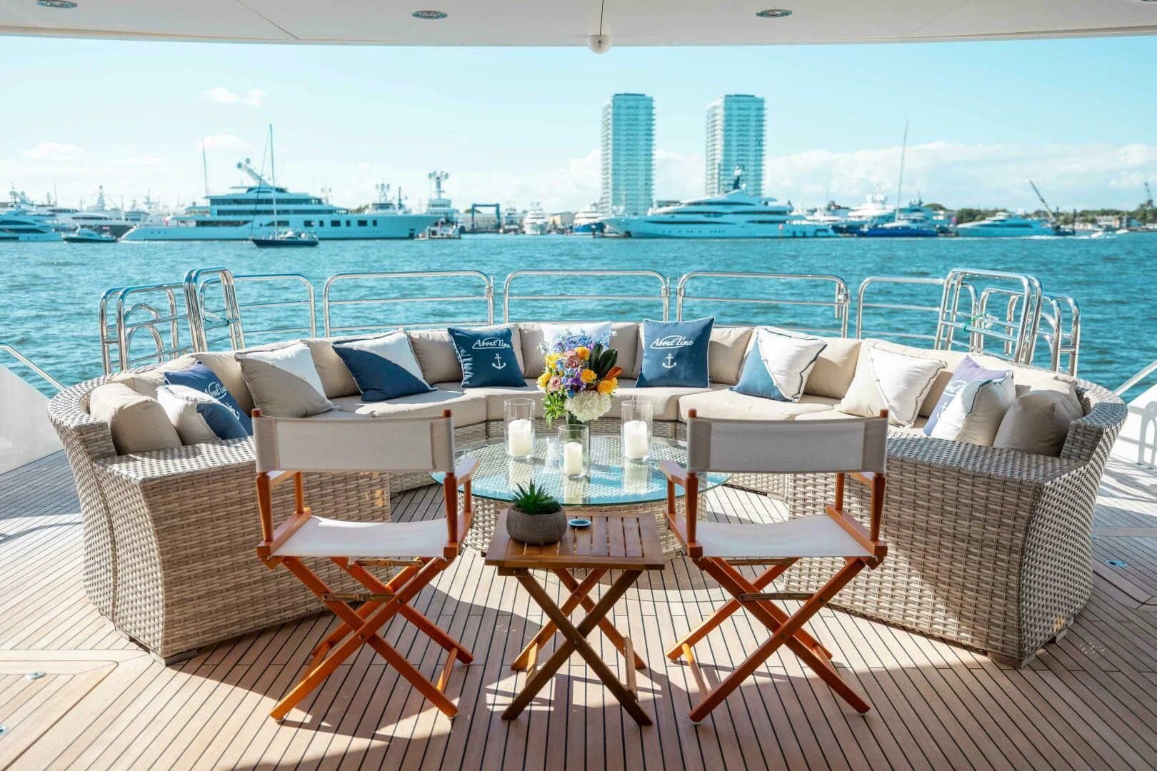 a table and chairs on a balcony overlooking a body of water aboard ABOUT TIME Yacht for Sale