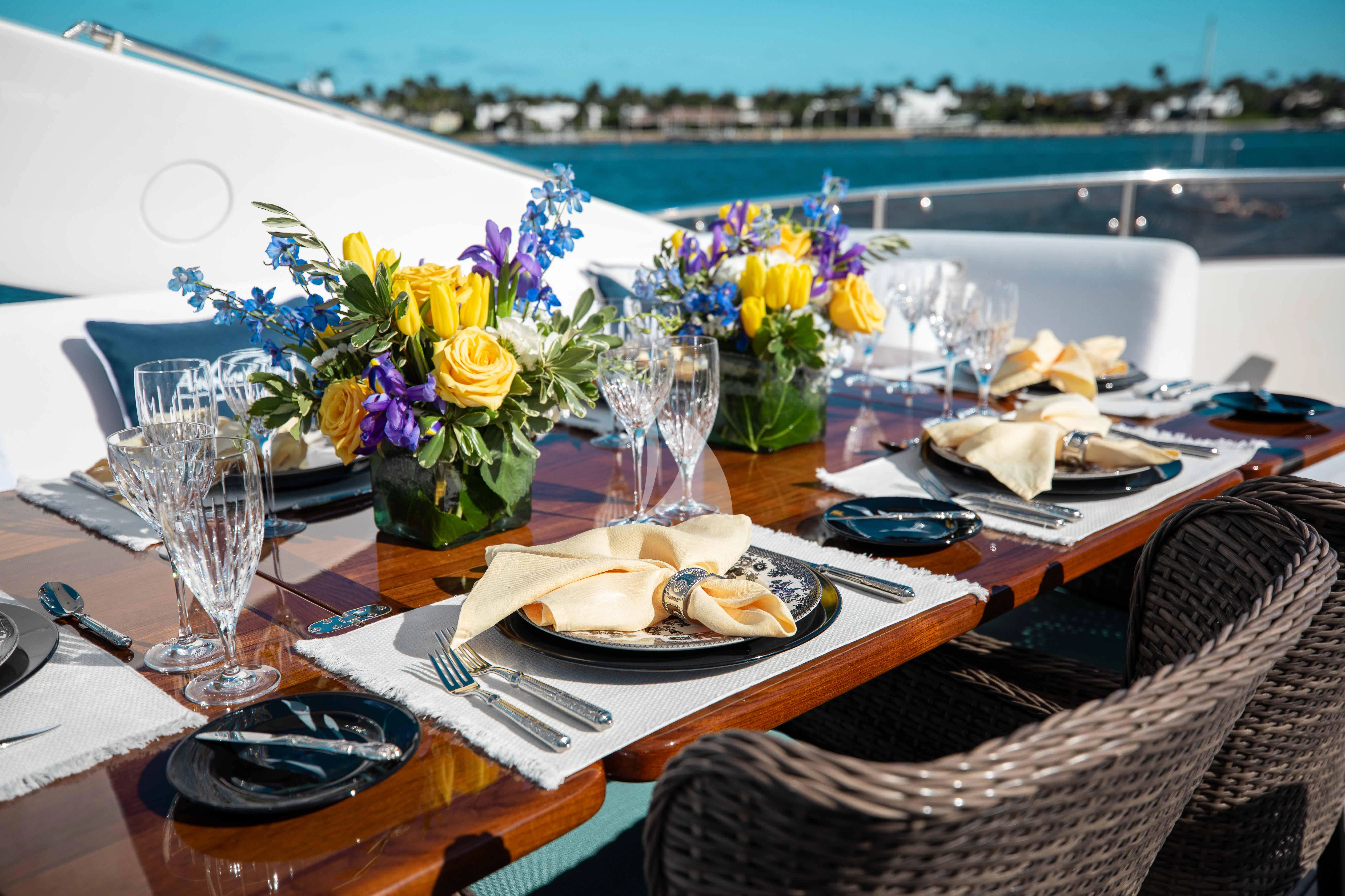 a table with plates and glasses aboard ABOUT TIME Yacht for Sale