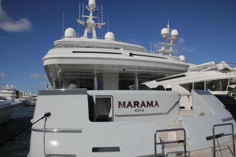 a white boat in a harbor aboard MARAMA Yacht for Sale