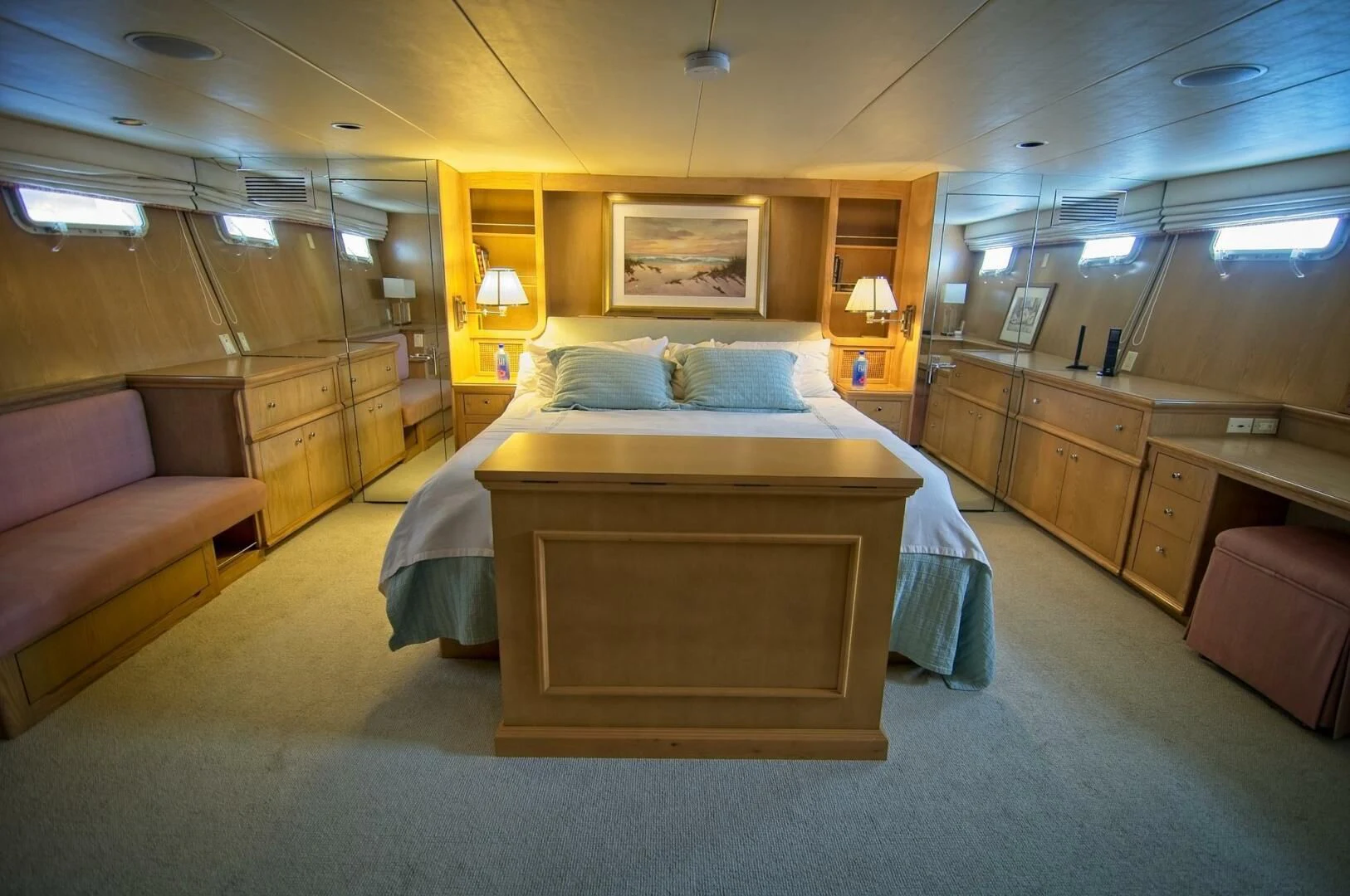 a bedroom with a bed and a couch aboard VICTORY Yacht for Sale