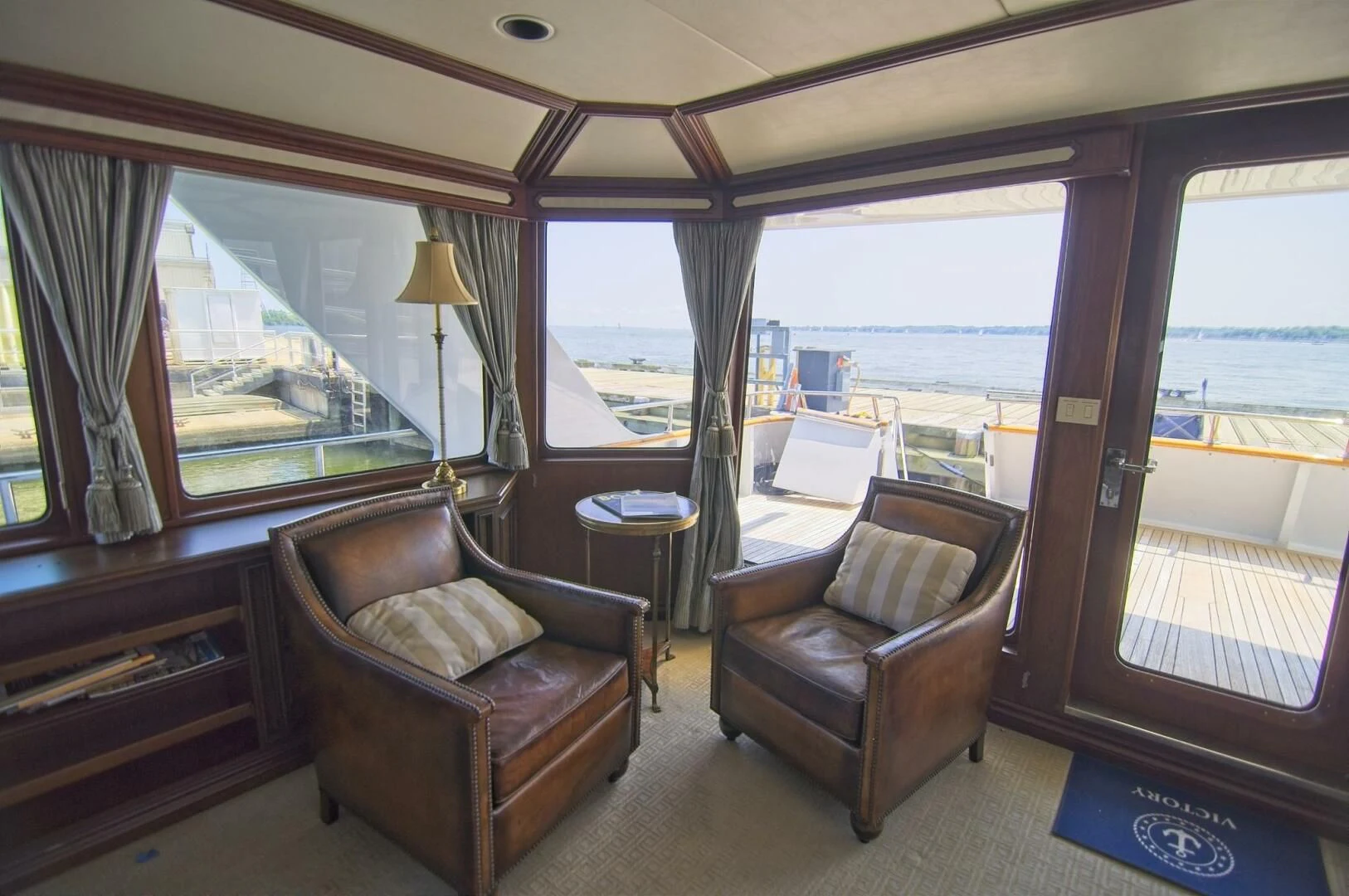a living room with a view of the ocean aboard VICTORY Yacht for Sale