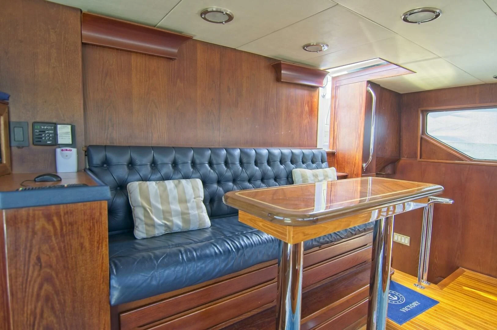 a living room with a couch and a table aboard VICTORY Yacht for Sale