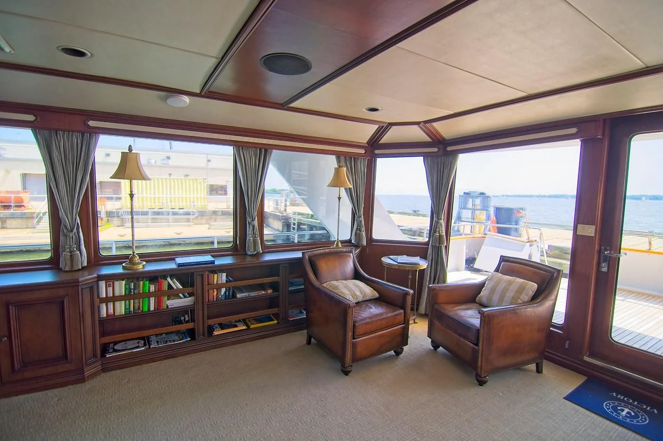 a living room with a large window aboard VICTORY Yacht for Sale