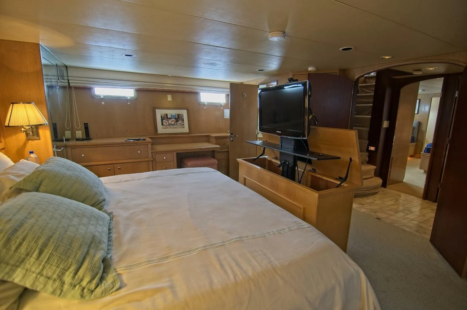 a bedroom with a bed and a tv aboard VICTORY Yacht for Sale