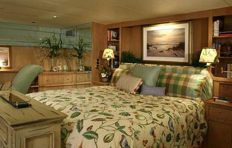 a bedroom with a bed and a desk aboard VICTORY Yacht for Sale