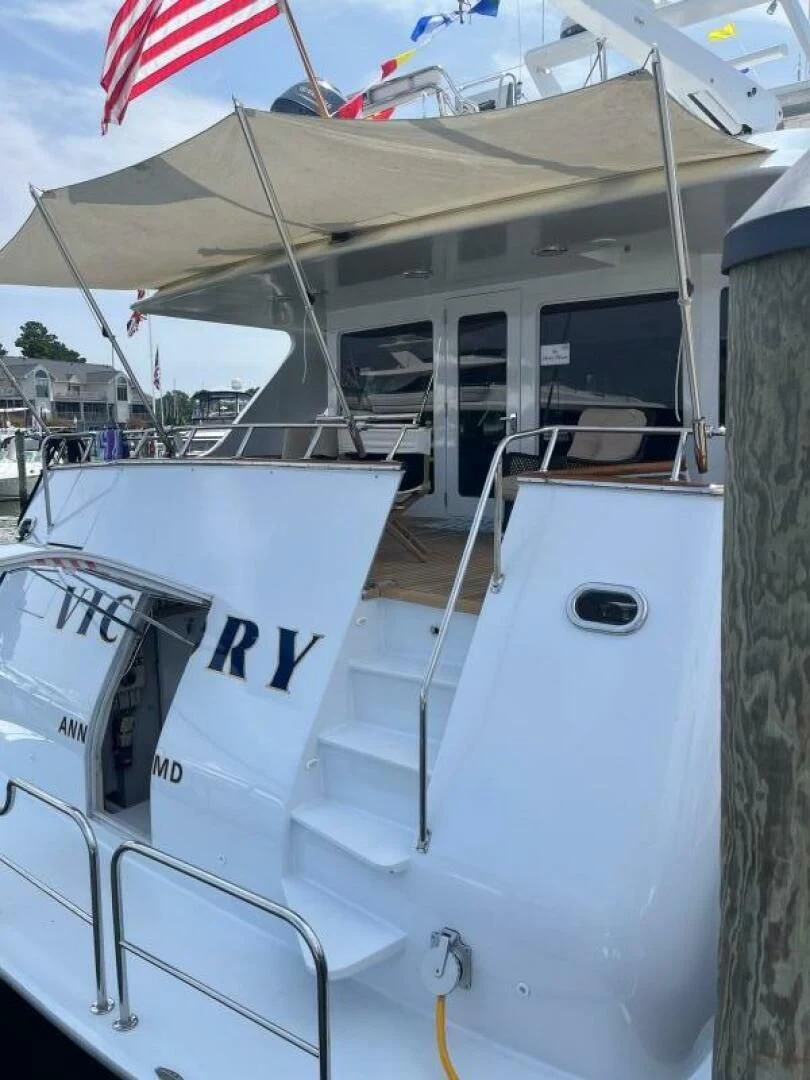 a boat with a flag on the deck aboard VICTORY Yacht for Sale