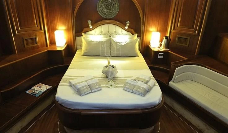 a hotel room with a bed and a lamp aboard KAPTAN MEHMET BUGRA Yacht for Sale