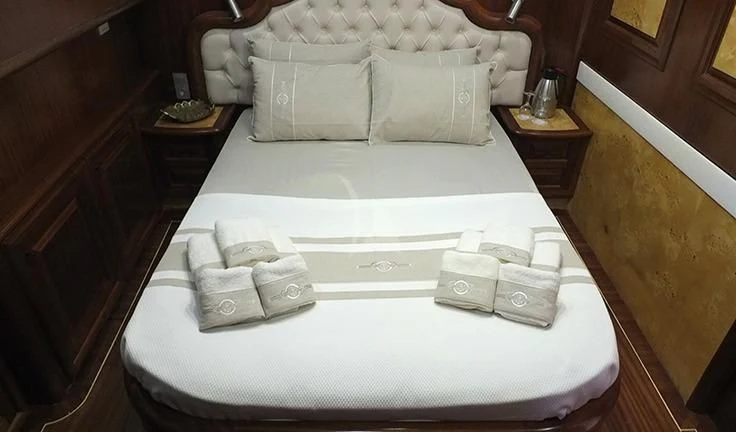 a bed with white towels aboard KAPTAN MEHMET BUGRA Yacht for Sale