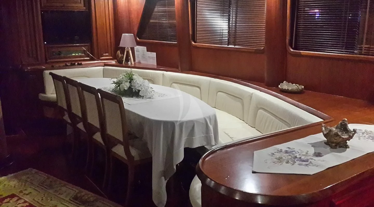 a dining table with flowers aboard KAPTAN MEHMET BUGRA Yacht for Sale