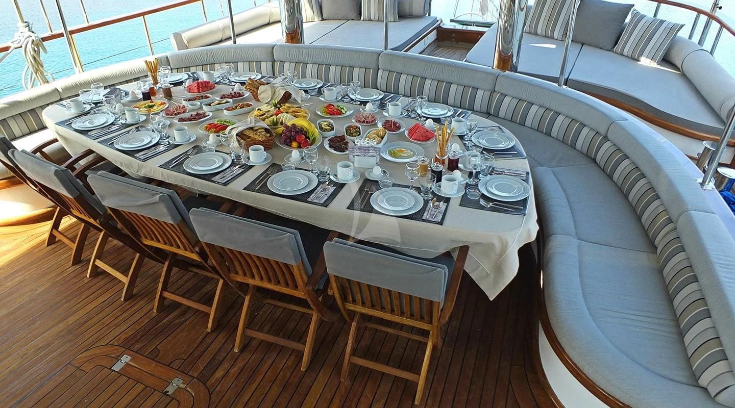 a table set for a dinner party aboard KAPTAN MEHMET BUGRA Yacht for Sale