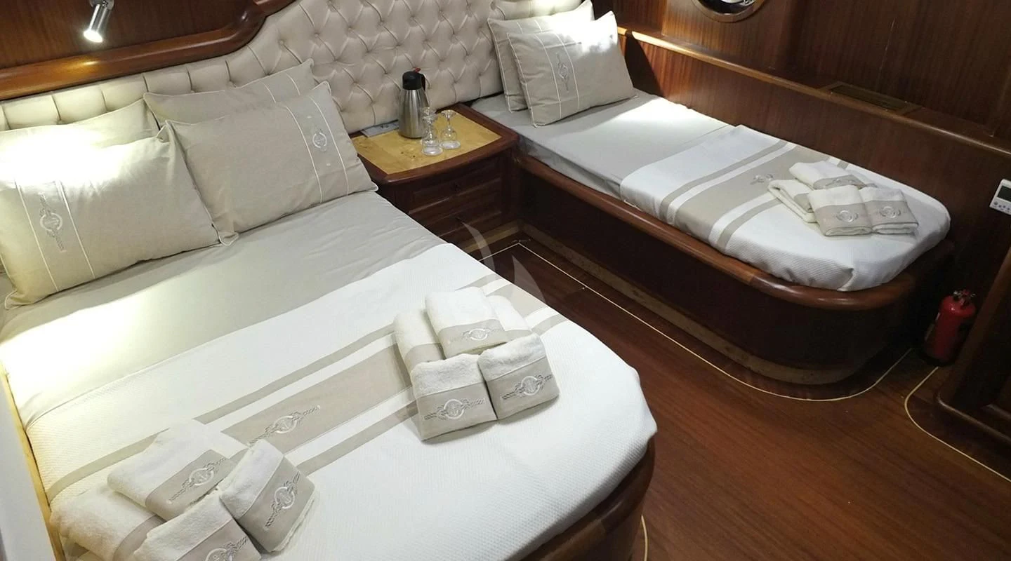 a couple of beds in a hotel room aboard KAPTAN MEHMET BUGRA Yacht for Sale