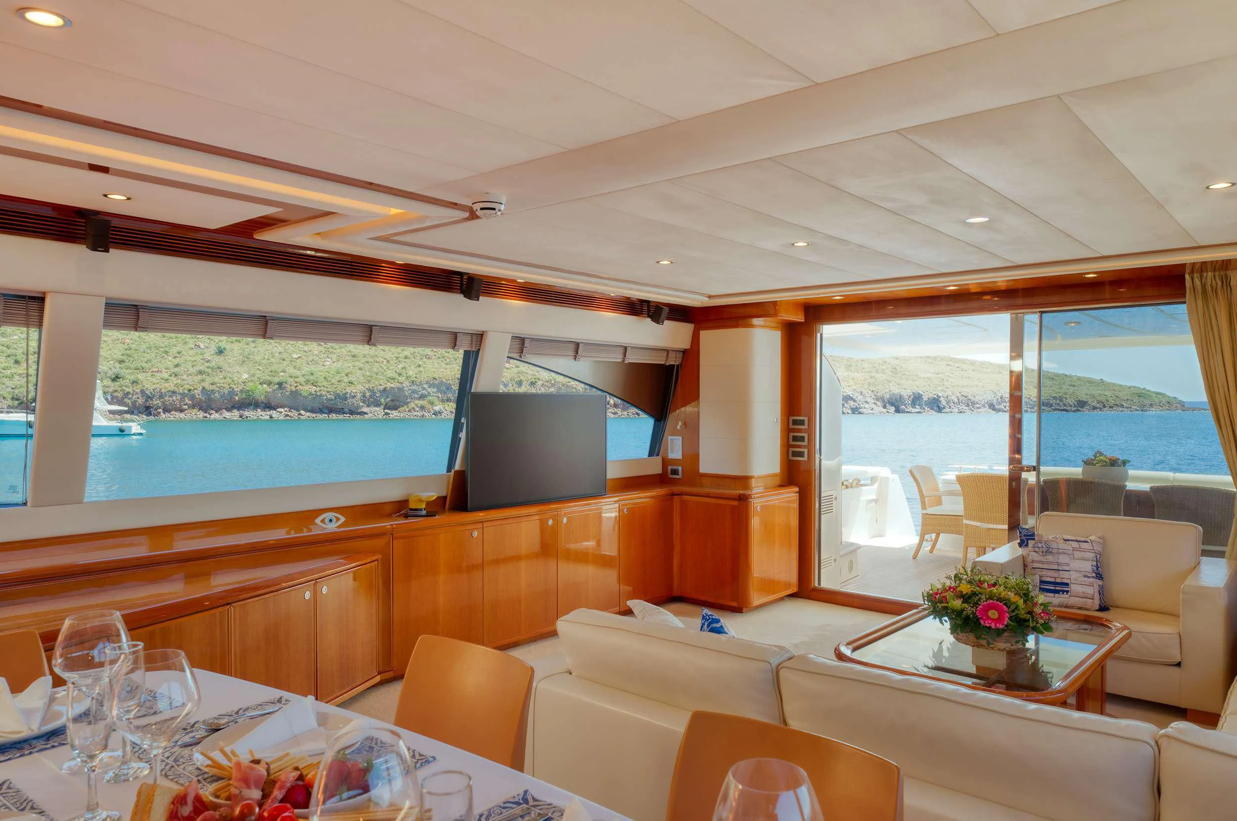 a room with a table and chairs aboard LIDIA Yacht for Sale