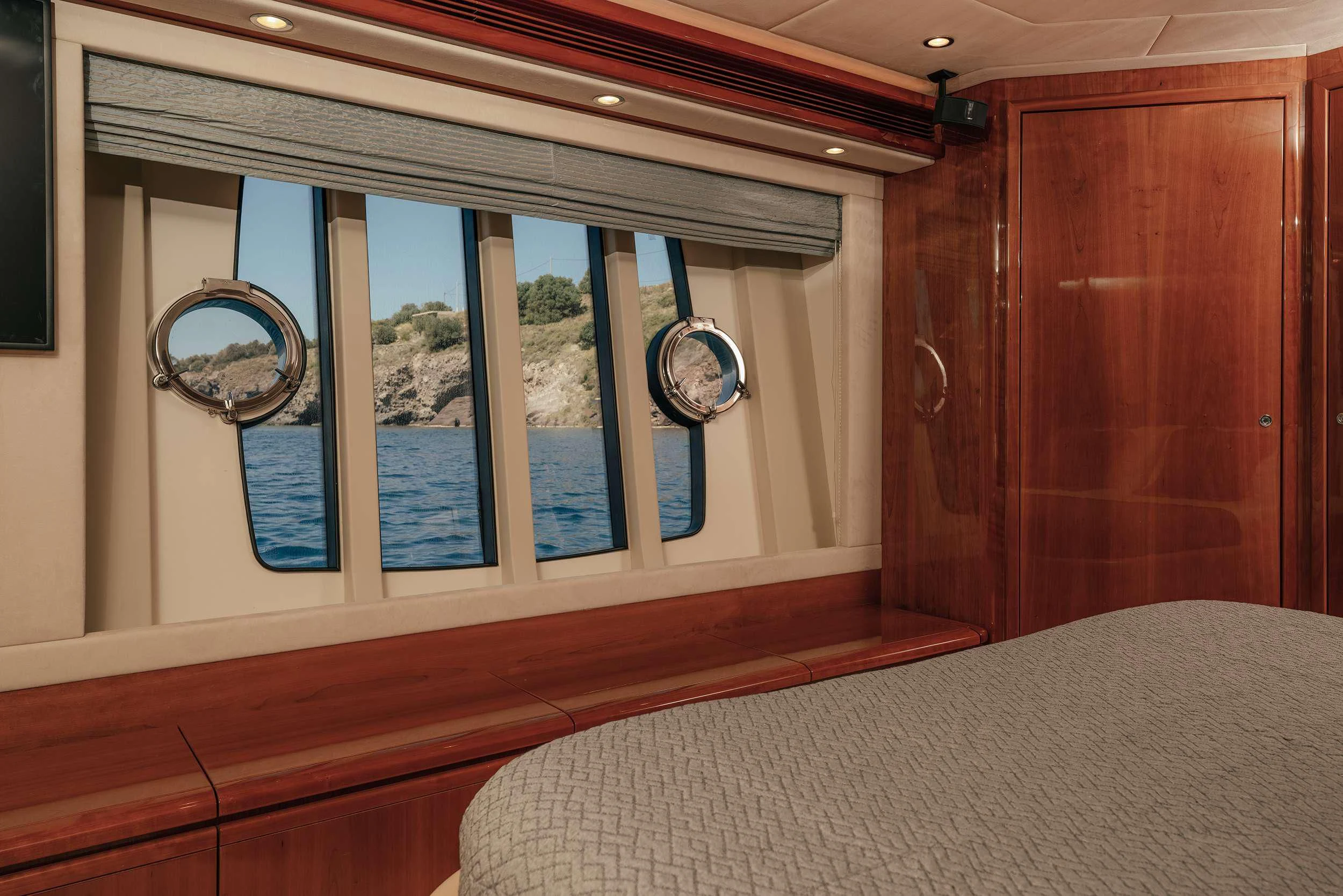 a room with a bed and a window aboard LIDIA Yacht for Sale