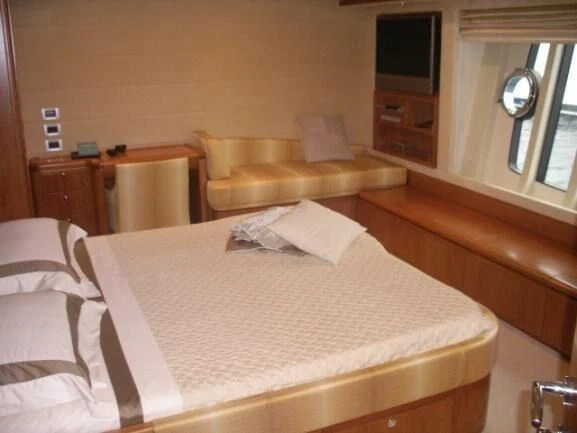 a bed with white sheets aboard LIDIA Yacht for Sale