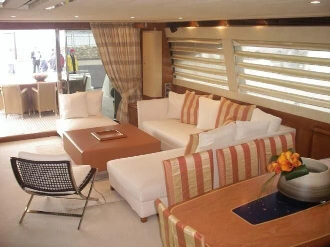 a living room with a table and chairs aboard LIDIA Yacht for Sale