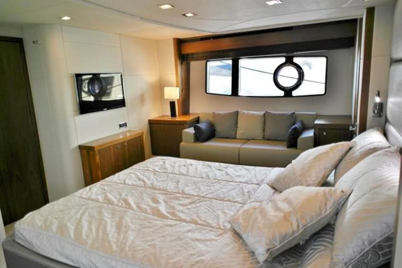 a bed with a white bed spread aboard SUNSEEKER MANHATTAN 63 Yacht for Sale