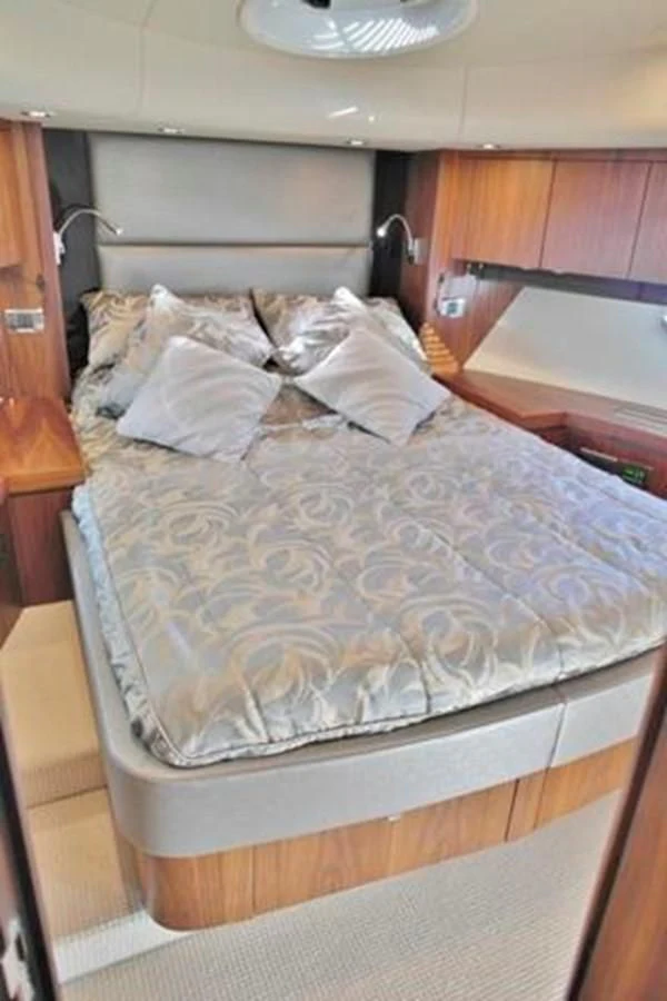 a bed with a white comforter aboard SUNSEEKER MANHATTAN 63 Yacht for Sale